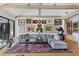 Cozy living room featuring hardwood floors, vaulted ceilings, gallery wall, and an oversized sofa at 1610 S Lake Shore Dr, Sarasota, FL 34231