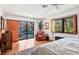 Bright bedroom with a view of the pool area, featuring a cozy reading chair and shuttered windows at 1610 S Lake Shore Dr, Sarasota, FL 34231
