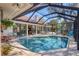 Spacious enclosed pool with multiple access points, tile surround, and outdoor furniture at 1610 S Lake Shore Dr, Sarasota, FL 34231