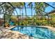Screened in pool with beautiful lush landscaping providing a private backyard oasis at 1610 S Lake Shore Dr, Sarasota, FL 34231