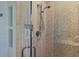 Close-up of a modern shower with beige textured tile and a built-in shelf at 1610 S Lake Shore Dr, Sarasota, FL 34231