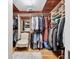 Organized walk-in closet with wooden accents, ample storage space, and a comfortable seating area at 1610 S Lake Shore Dr, Sarasota, FL 34231