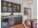 Modern wet bar area with wine fridge and glass display cabinets at 1610 S Lake Shore Dr, Sarasota, FL 34231