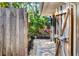 Charming garden featuring a wooden fence and a variety of flowering plants and trees at 1610 S Lake Shore Dr, Sarasota, FL 34231