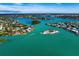 Stunning aerial view of waterfront homes surrounded by clear blue water, islands, and lush greenery at 201 Eaglenook Way, Osprey, FL 34229