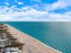 Expansive coastline view with turquoise water, sandy beaches, and lush vegetation from above at 201 Eaglenook Way, Osprey, FL 34229