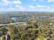 Aerial view showcasing community lakes, roads, and lush landscaping in neighborhood at 201 Eaglenook Way, Osprey, FL 34229