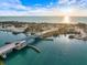 Aerial view of a bridge and ocean inlet with sunny sky, showing traffic and waterside establishments at 201 Eaglenook Way, Osprey, FL 34229