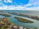 Breathtaking aerial view of the coastline and islands with turquoise waters and blue skies at 201 Eaglenook Way, Osprey, FL 34229