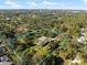 Aerial view of a private home and pool surrounded by lush trees, blue sky, and outlined in blue at 201 Eaglenook Way, Osprey, FL 34229