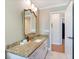 Bathroom vanity with granite counters, modern fixtures, and white cabinets at 201 Eaglenook Way, Osprey, FL 34229