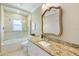 Bathroom with bathtub, glass shower enclosure, and granite vanity at 201 Eaglenook Way, Osprey, FL 34229