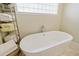 Modern bathroom featuring a freestanding bathtub with chrome fixtures and decorative towels at 201 Eaglenook Way, Osprey, FL 34229