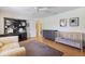 Bedroom with crib, desk, ceiling fan, and wood flooring at 201 Eaglenook Way, Osprey, FL 34229