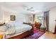 Bedroom with ceiling fan, closet, and wood flooring at 201 Eaglenook Way, Osprey, FL 34229