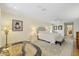 Well lit primary bedroom with a decorative rug, ceiling fan, and ensuite bathroom with vanity at 201 Eaglenook Way, Osprey, FL 34229
