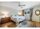 Bedroom features a floral comforter, wood floors, a ceiling fan and a window view to the outdoors at 201 Eaglenook Way, Osprey, FL 34229