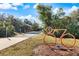 Community bike path with a covered rest stop, landscaping, and trail markers at 201 Eaglenook Way, Osprey, FL 34229