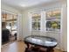 Bright dining area with sliding glass doors to the pool area and an ornate glass-topped table at 201 Eaglenook Way, Osprey, FL 34229