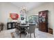 Open dining area with tiled floors, chandelier, and views of the outdoor pool area at 201 Eaglenook Way, Osprey, FL 34229