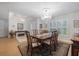 The formal dining room features a chandelier, an area rug, and wood table set with seating for six at 201 Eaglenook Way, Osprey, FL 34229