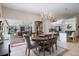 Open-concept dining area with a chandelier, opening to the living room and kitchen at 201 Eaglenook Way, Osprey, FL 34229