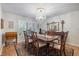 Formal dining room featuring a chandelier, an area rug, and wood table set with seating for six at 201 Eaglenook Way, Osprey, FL 34229