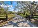 Long driveway leads to this serene home, framed by mature trees and lush landscaping for ultimate privacy at 201 Eaglenook Way, Osprey, FL 34229