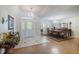 Bright foyer area with chandelier and a view to the dining room, wood floors, and a decorative front door at 201 Eaglenook Way, Osprey, FL 34229