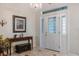 Foyer features tiled floors, console table with decor, a decorative mirror and a patterned glass front door at 201 Eaglenook Way, Osprey, FL 34229