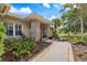 Charming front entrance with brick features, complemented by lush greenery and manicured landscaping at 201 Eaglenook Way, Osprey, FL 34229