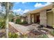 Inviting front entrance with brick pillars, a red door, and well-maintained landscaping along the walkway at 201 Eaglenook Way, Osprey, FL 34229