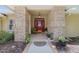 Inviting front entrance with brick columns, a red front door, and a landscaped walkway at 201 Eaglenook Way, Osprey, FL 34229