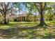 Charming home featuring stone accents, mature trees, and a well-manicured lawn for great curb appeal at 201 Eaglenook Way, Osprey, FL 34229