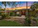 Charming home featuring a landscaped front yard, brick accents, and a welcoming red front door at sunset at 201 Eaglenook Way, Osprey, FL 34229