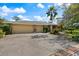 Spacious three-car garage with brick-lined driveway and lush landscaping offering ample parking at 201 Eaglenook Way, Osprey, FL 34229
