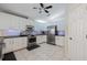 Modern kitchen with stainless steel appliances, black countertops, white cabinets and tile flooring at 201 Eaglenook Way, Osprey, FL 34229