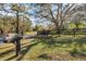 Charming mailbox and fencing with lush front lawn, mature trees, and home in the background at 201 Eaglenook Way, Osprey, FL 34229