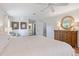 This spacious main bedroom features a ceiling fan, dresser, and is filled with natural light at 201 Eaglenook Way, Osprey, FL 34229