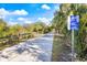 Well-maintained community nature trail featuring shaded paths, signage, and wooden fencing at 201 Eaglenook Way, Osprey, FL 34229