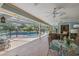 Outdoor patio with ceiling fans, view to the backyard, pool, and comfortable seating at 201 Eaglenook Way, Osprey, FL 34229