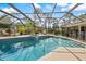 Large screened-in pool surrounded by mature trees and greenery at 201 Eaglenook Way, Osprey, FL 34229