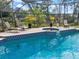 Screened-in pool area with lounge chairs and jacuzzi, great for outdoor relaxation at 201 Eaglenook Way, Osprey, FL 34229