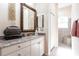 Bright bathroom vanity with granite counter, vessel sink, and decorative mirror at 2123 Lynx Run, North Port, FL 34288