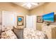 Bedroom featuring floral bedding, neutral walls, ceiling fan, and television at 2123 Lynx Run, North Port, FL 34288