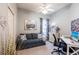 Comfortable bedroom with a sofa, desk, and ceiling fan, perfect for relaxation and work at 2123 Lynx Run, North Port, FL 34288