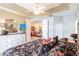 Bedroom features tray ceiling, dresser, and an open doorway to another room at 2123 Lynx Run, North Port, FL 34288