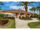 Exterior of the community clubhouse surrounded by mature palm trees and well-kept landscaping at 2123 Lynx Run, North Port, FL 34288