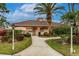 Exterior view of the community clubhouse with lush landscaping and ample parking at 2123 Lynx Run, North Port, FL 34288