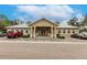 Exterior view of the community center with ample parking, showcasing its inviting facade at 2123 Lynx Run, North Port, FL 34288